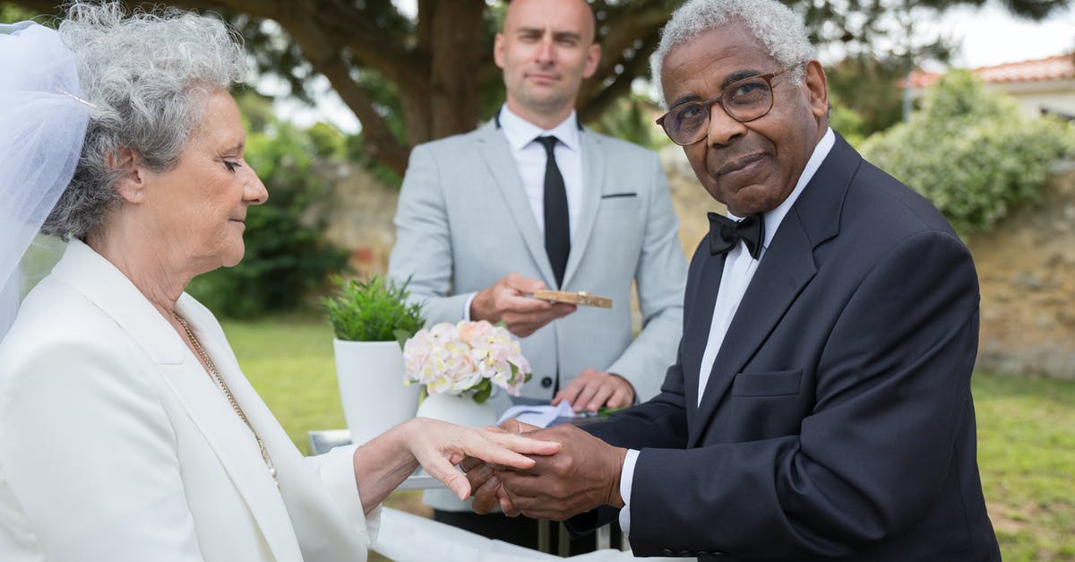 Schengen visa 1 day longer than duration - Man in Black Suit Holding Bouquet of Flowers