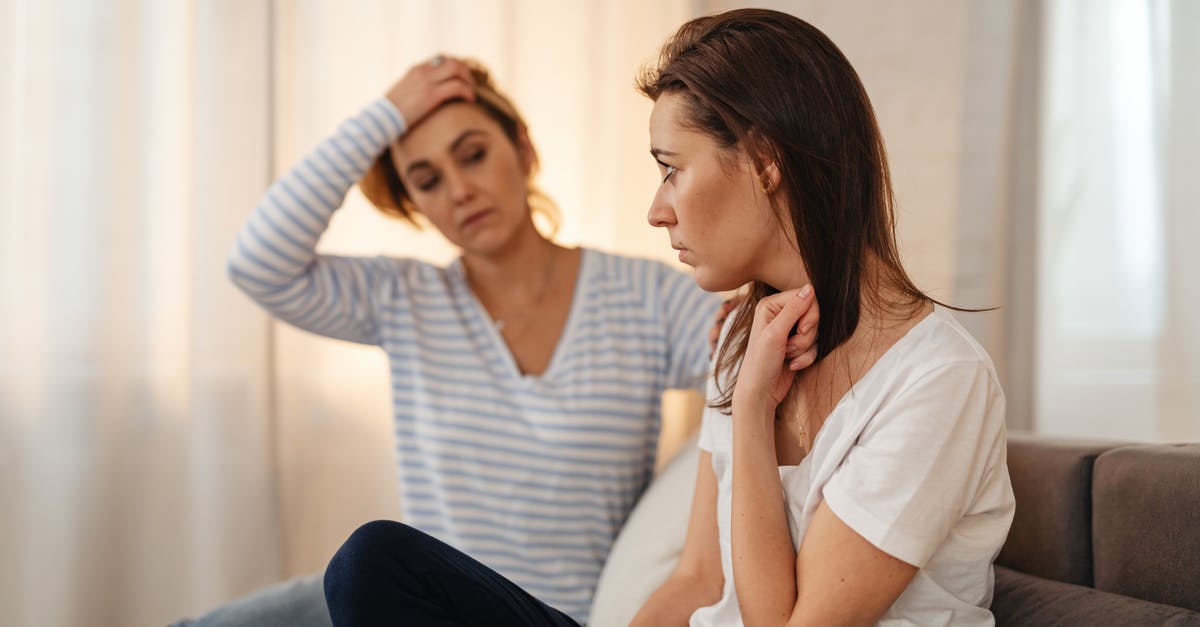 Schengen visa - worried about being refused - Worried Woman Sitting on a Sofa 