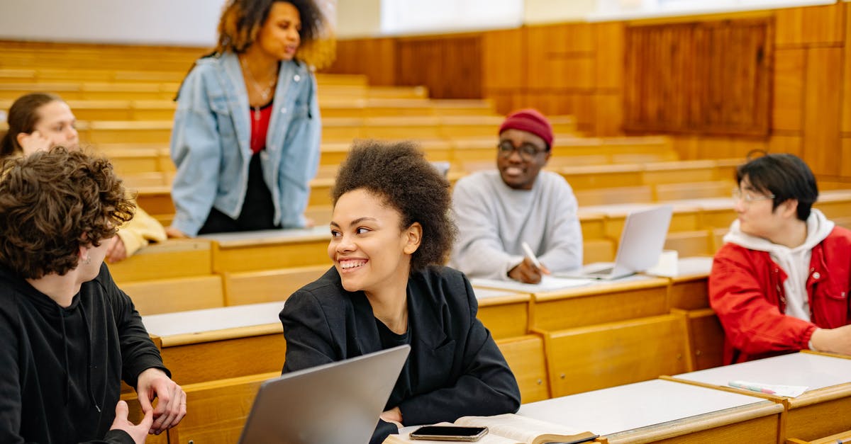 Schengen Visa and International Students - Man in Black Long Sleeve Shirt Using Macbook