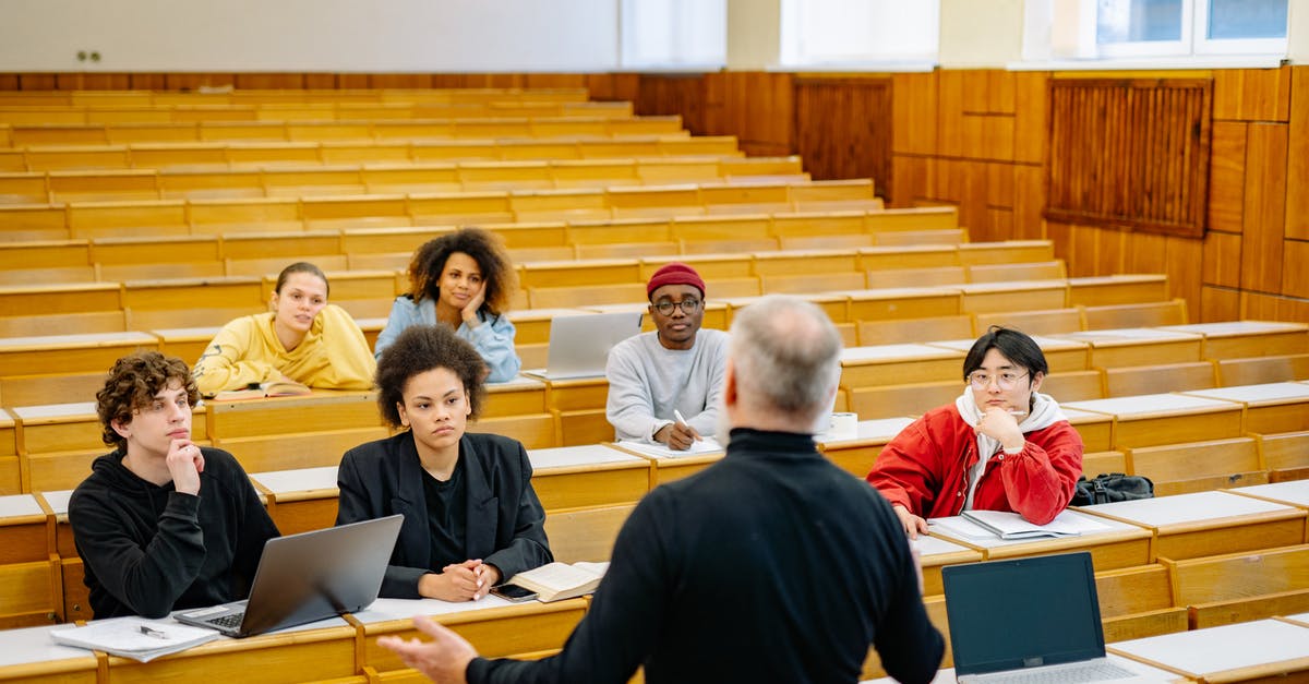 Schengen Visa and International Students - People Sitting on Chairs in Front of Table