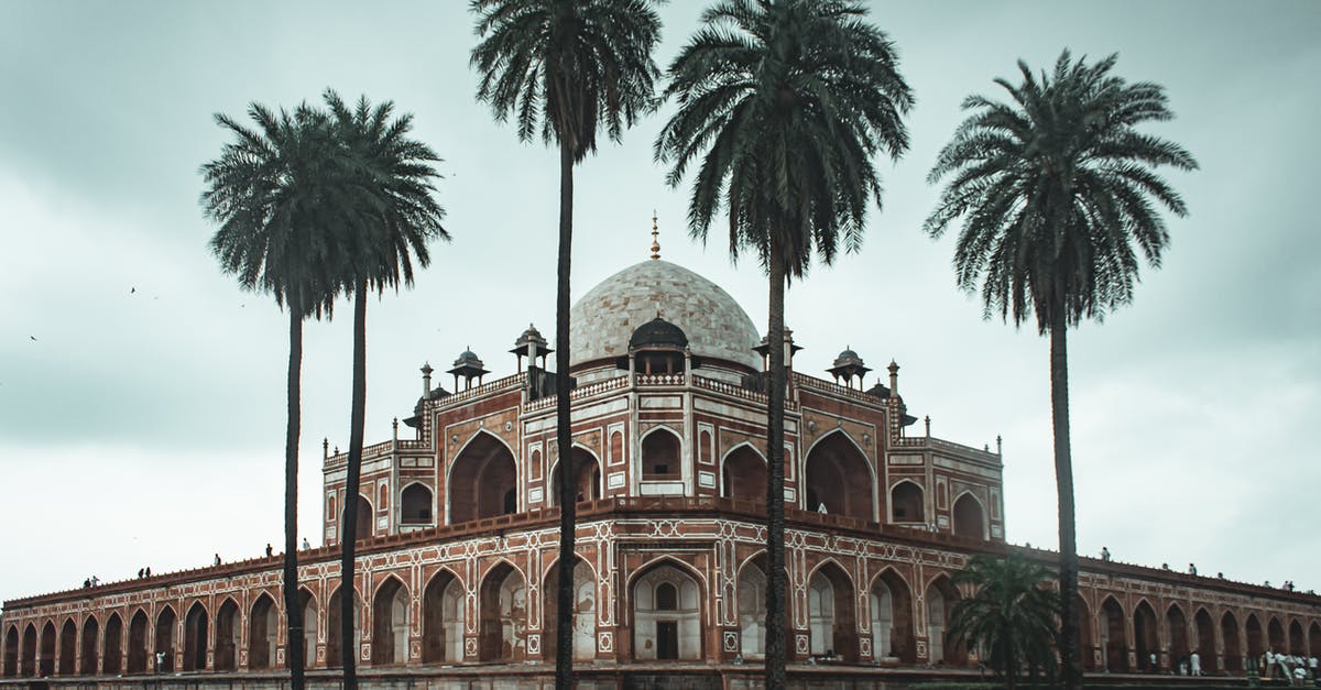 Schengen visa application in USA but next destination is India - Low angle of beautiful well maintained garden with palms and ancient building of Humayun s Tomb located in Delhi