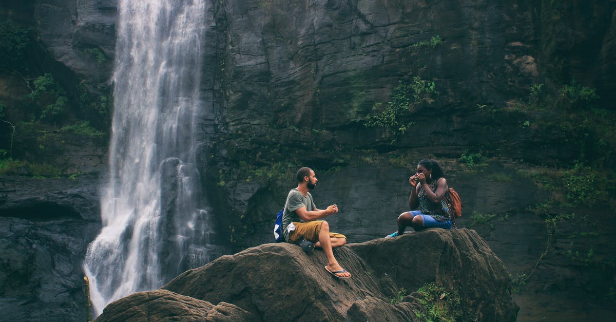 Schengen visa cancelled and traveller searched - Man and Woman Near Waterfall