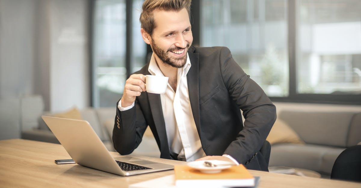 Schengen visa entering twice with a break - Man Holding White Teacup in Front of Gray Laptop