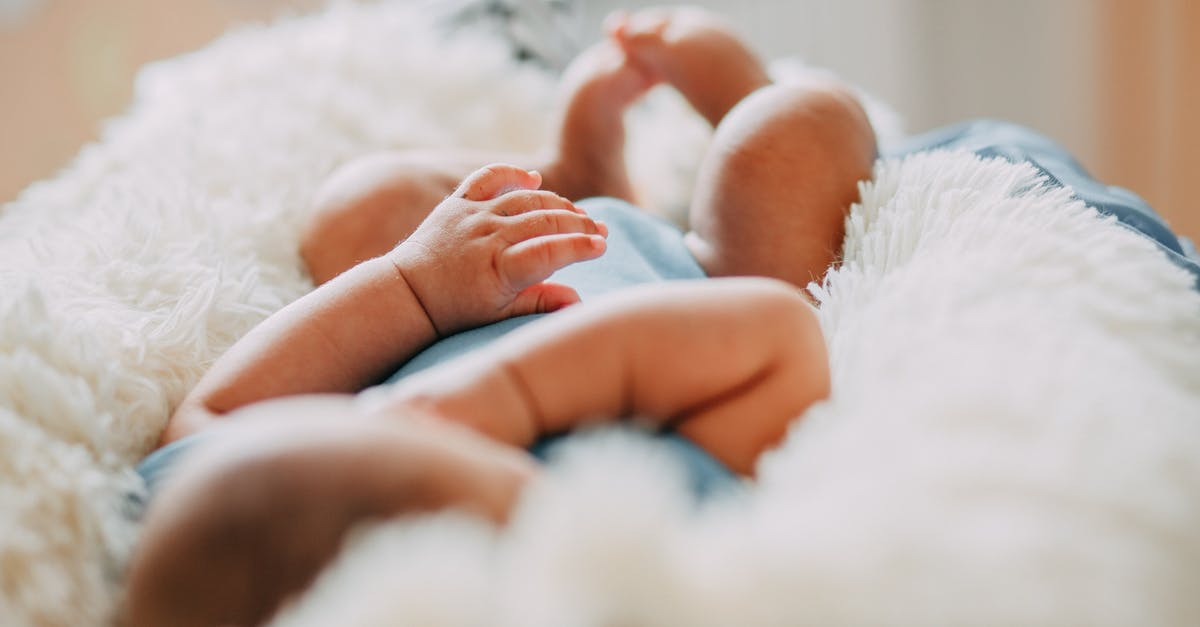 Schengen visa for a US born Baby - Photo Of Baby Laying On Fleece Blanket