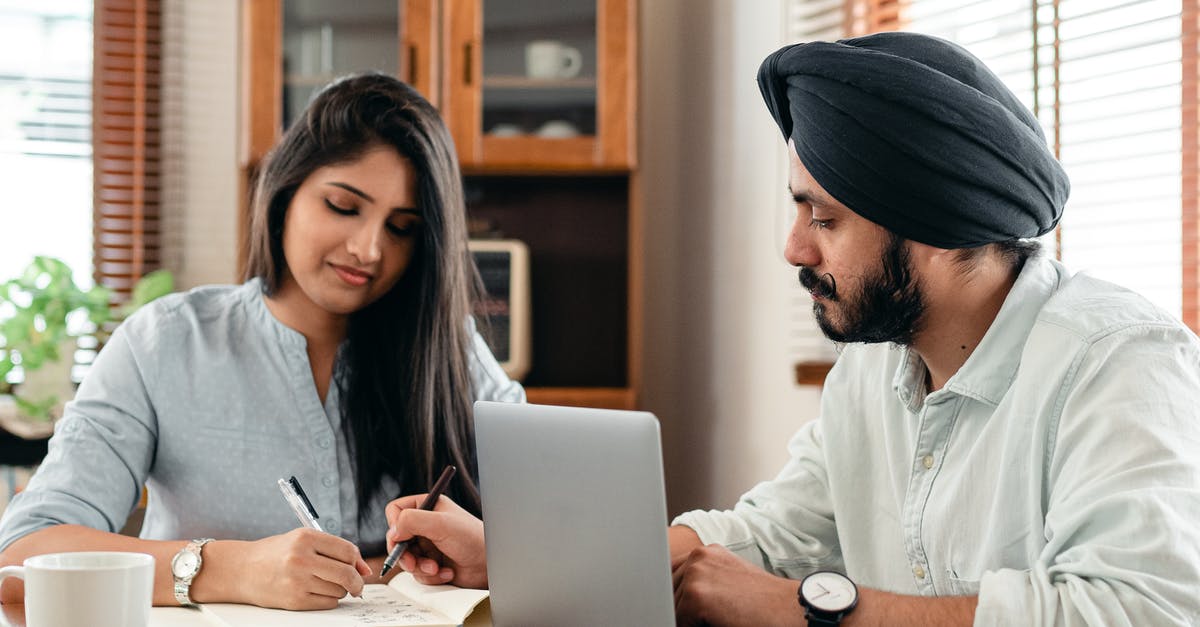 Schengen visa for an Indian student in Ireland - Focused tutor and student doing homework assignment using laptop