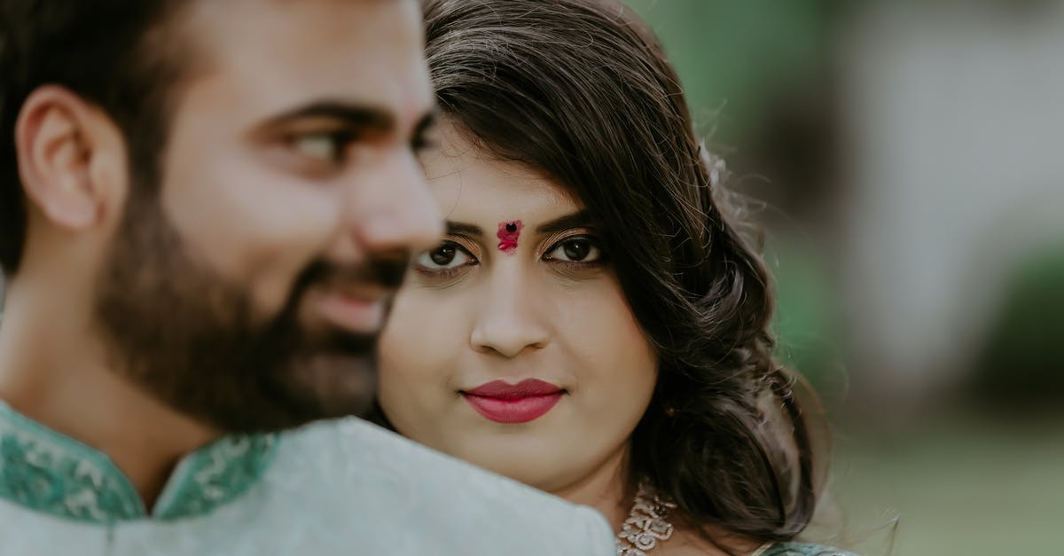 Schengen visa for Pakistani national married to British citizen wife - Cheerful couple of husband and wife in national wearing with bindi in soft focus