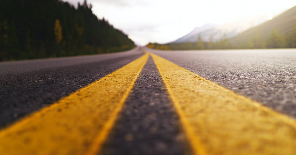 Schengen visa for separate 1-week travels with 3 months in-between - Yellow and Black Road in Between Green Trees Under White Clouds