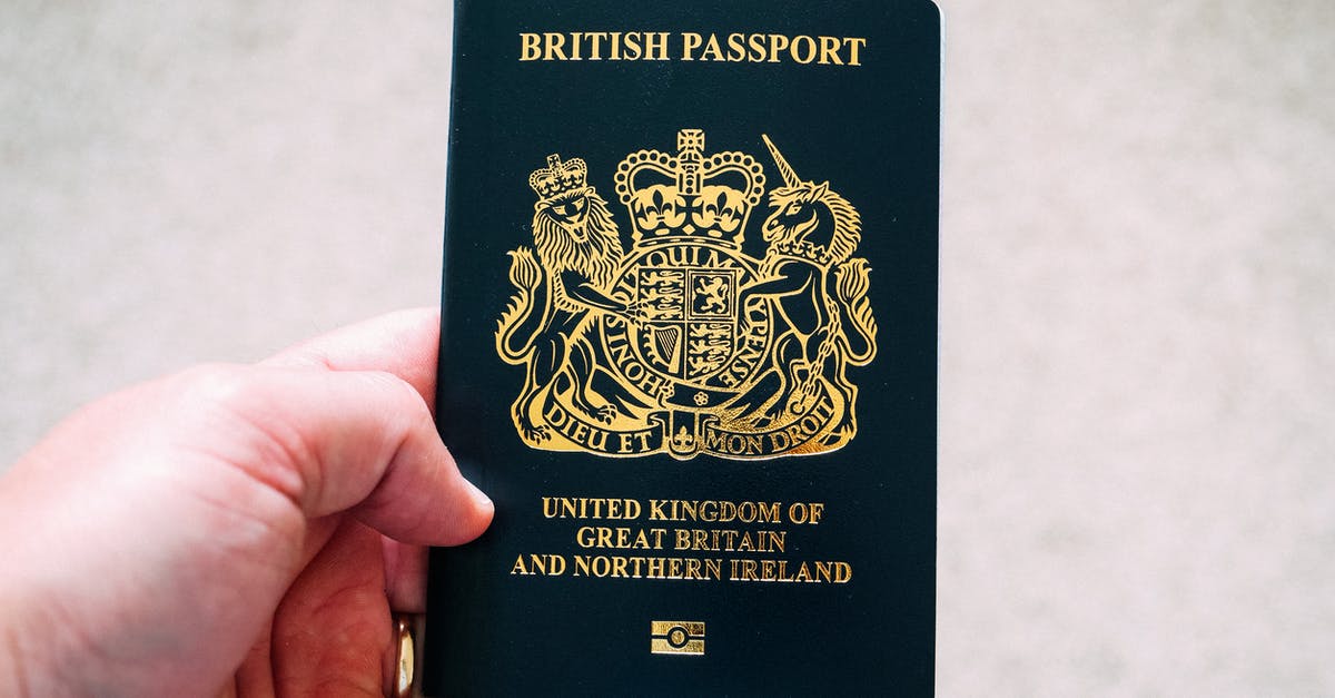 Schengen visa, in refugee travel document from USA - Crop unrecognizable person demonstrating British passport