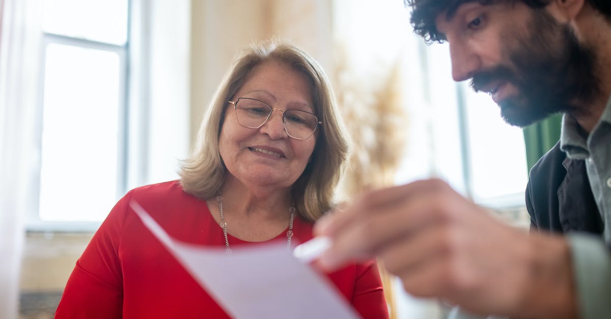 Schengen visa insurance duration [duplicate] - Woman in Red and White Long Sleeve Shirt Holding White Paper