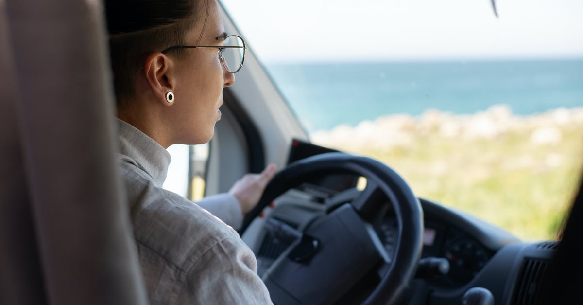 Schengen Visa query for my trip - A Woman with Eyeglasses Driving a Car