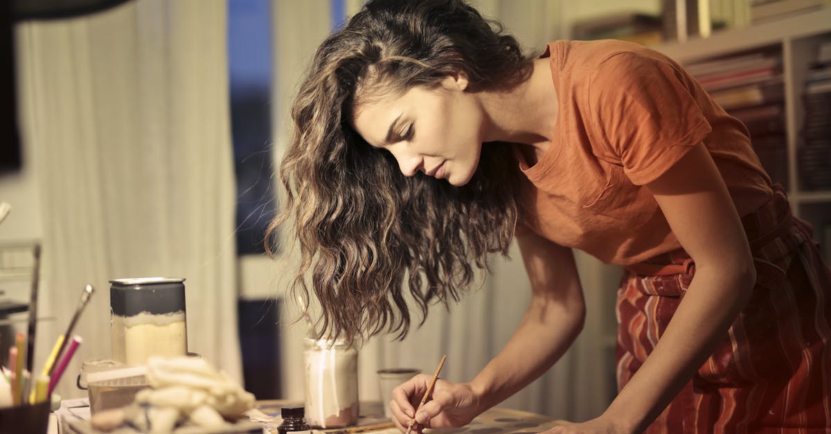 Schengen Visa Refusal: Does it make sense to appeal? - Concentrated redhead female wearing light apron kneading clay in baking pan while creating in modern apartment