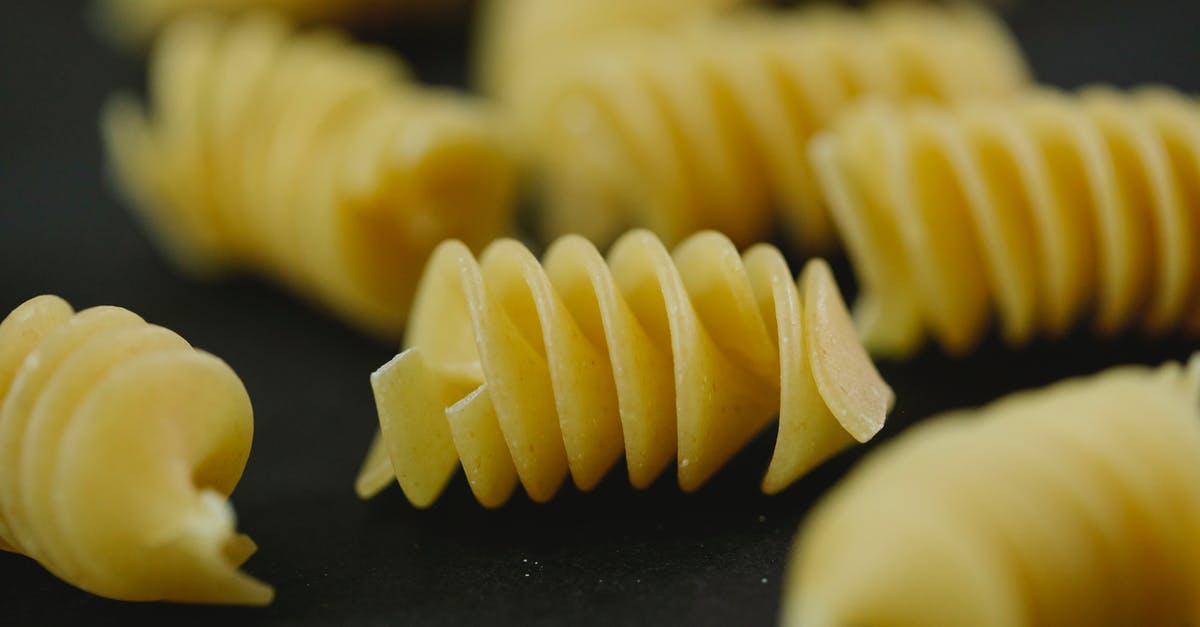 schengen visa refusal for italy [closed] - Closeup of heap of uncooked dried traditional Italian pasta fusilli on blurred background