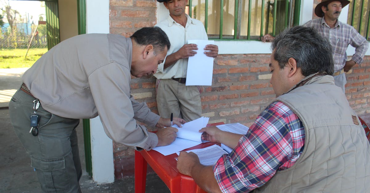 Schengen visa requirements for seafarers signing off - Man signing a Document 