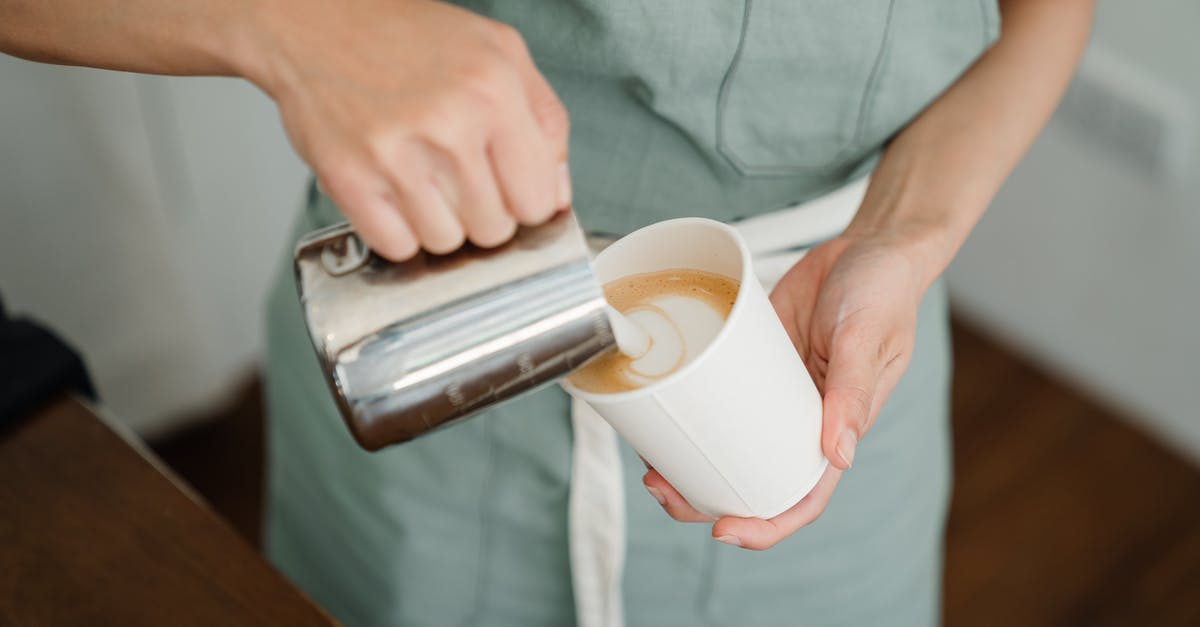 schengen visa taking to much processing time - Crop barista pouring milk froth in cappuccino for client