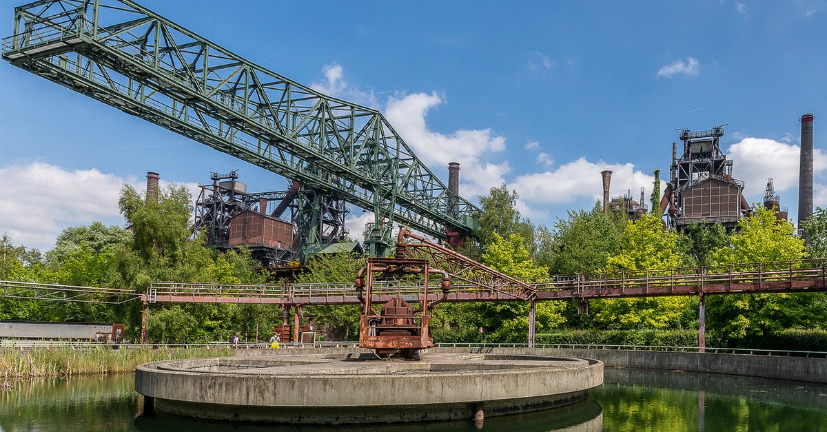 Schengen Zone enter/reentry [closed] - Red and Black Metal Crane Near Green Trees Under Blue Sky