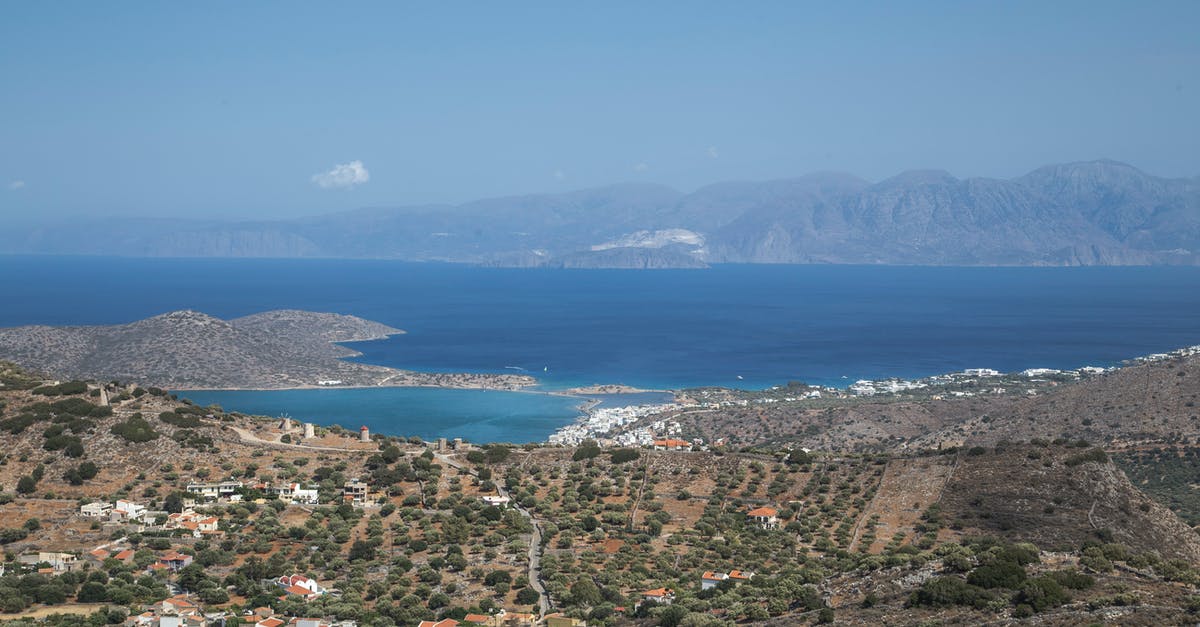 Scooter on Crete, Greece - Breathtaking scenery of coastal town near blue sea
