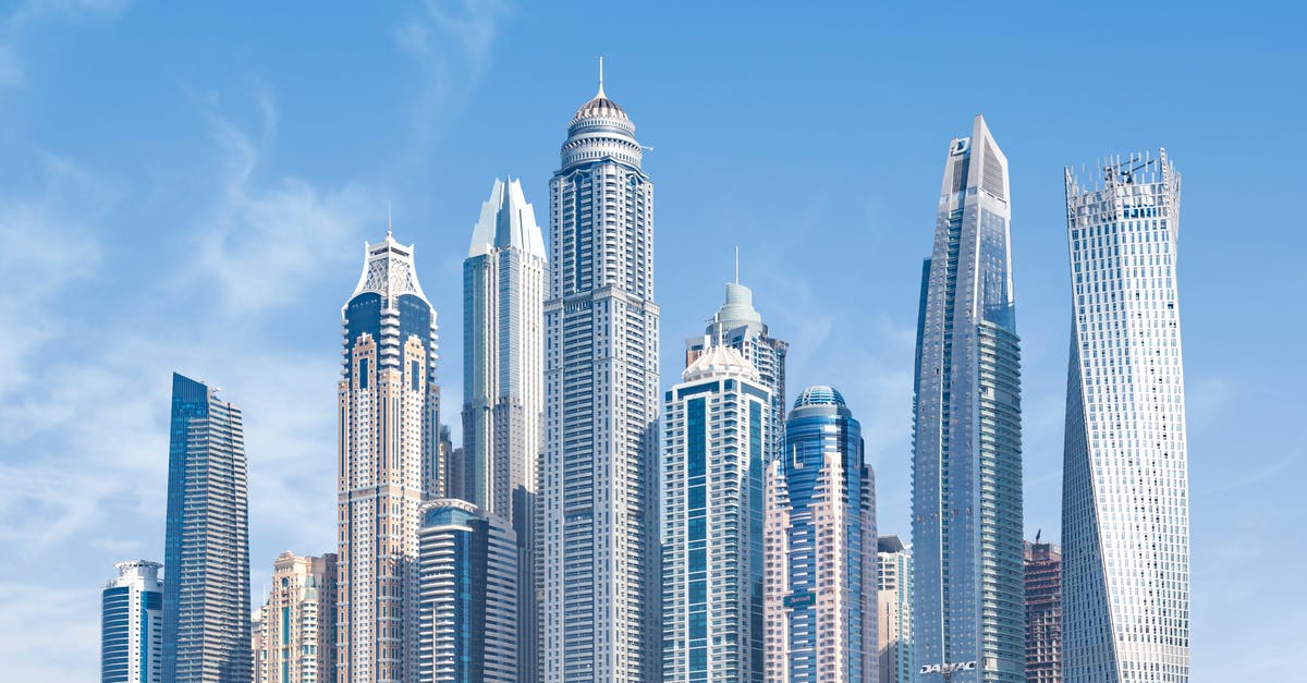 Seafarer transiting through Dubai - Concrete High-rise Buildings Under Blue Sky