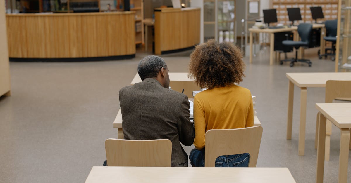 Seat aisles blocked by baggage - Man in Gray Long Sleeve Shirt Sitting on Brown Chair