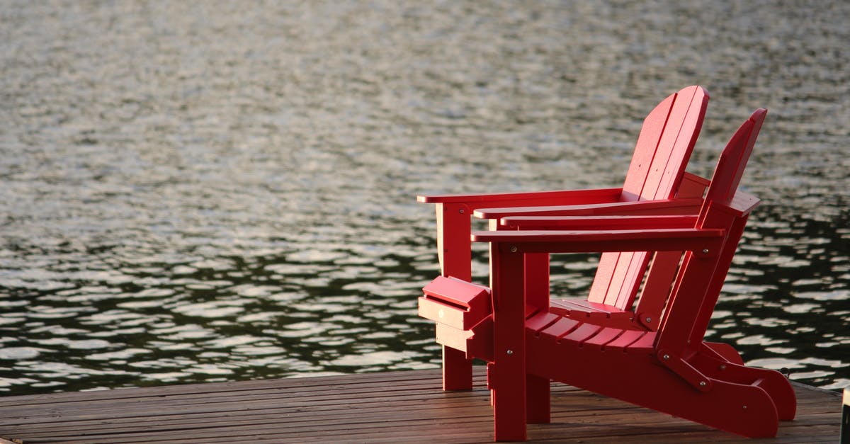 Seat Assignment on Via Rail's The Ocean - Red Wooden Lounge Chair on Brown Boardwalk Near Body of Water during Daytime