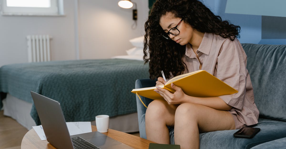 Seat selection when using online booking sites - A Young Woman Writing in a Notebook While Sitting on a Couch