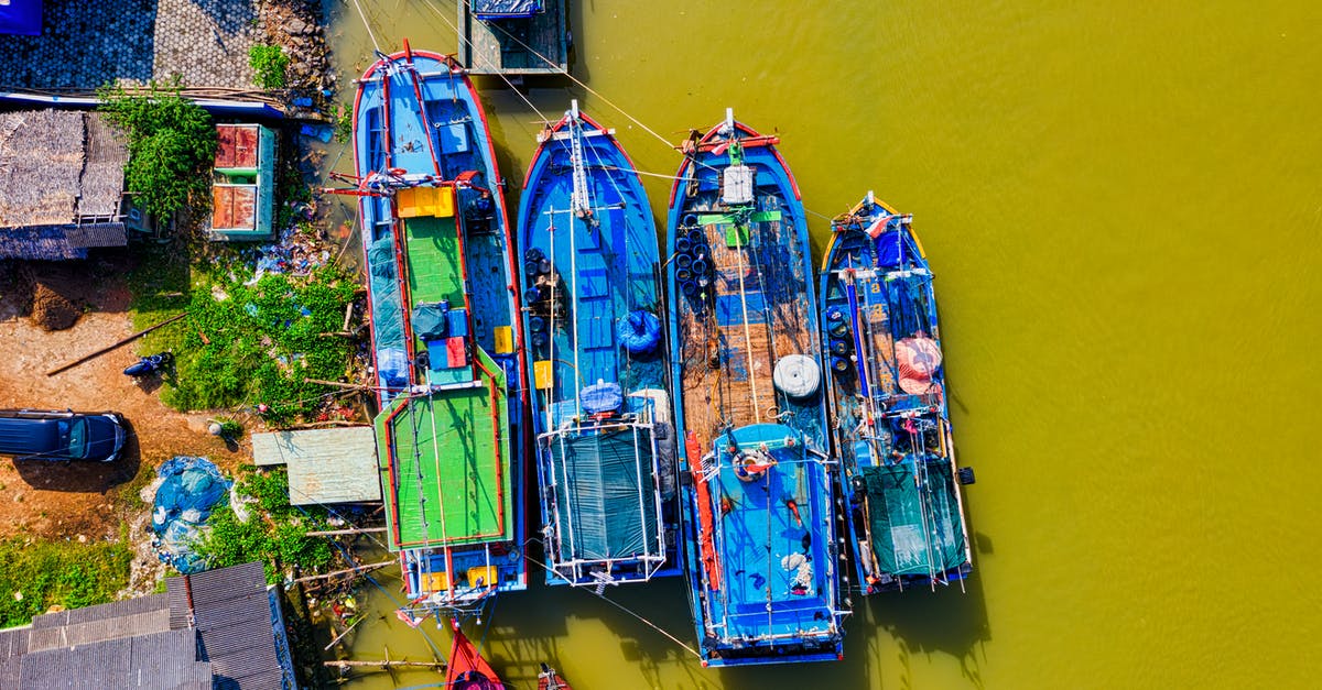 Second 60 days tourist visa Indonesia - Lined Blue and Green Painted Boats