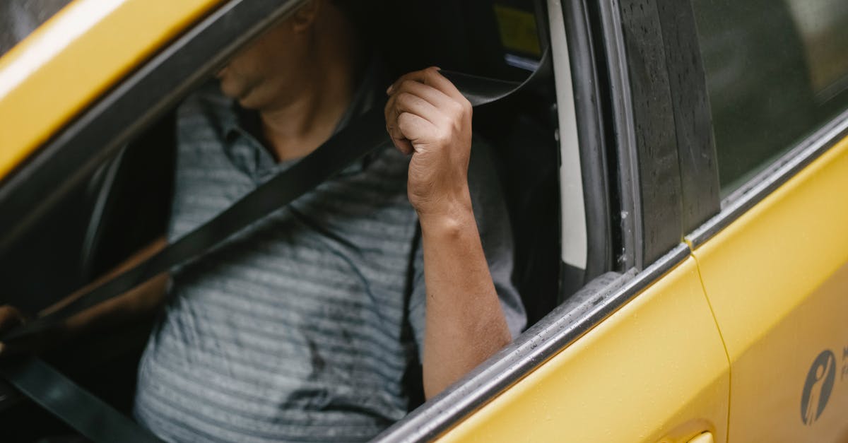 Secure long-term parking in Johannesburg - Unrecognizable male driver sitting in cab and fastening seat belt