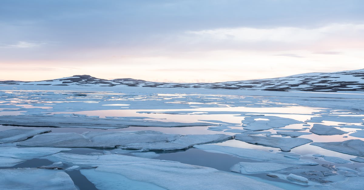 Seeing polar bears in Churchill, Manitoba in spring? - Winter river with cracked ice on rocky terrain