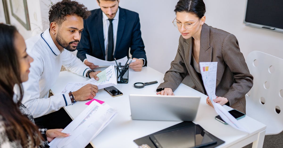 Seeking spreadsheet template for planning multiple people/city visits - Man in Black Suit Jacket Sitting Beside Man in Gray Blazer