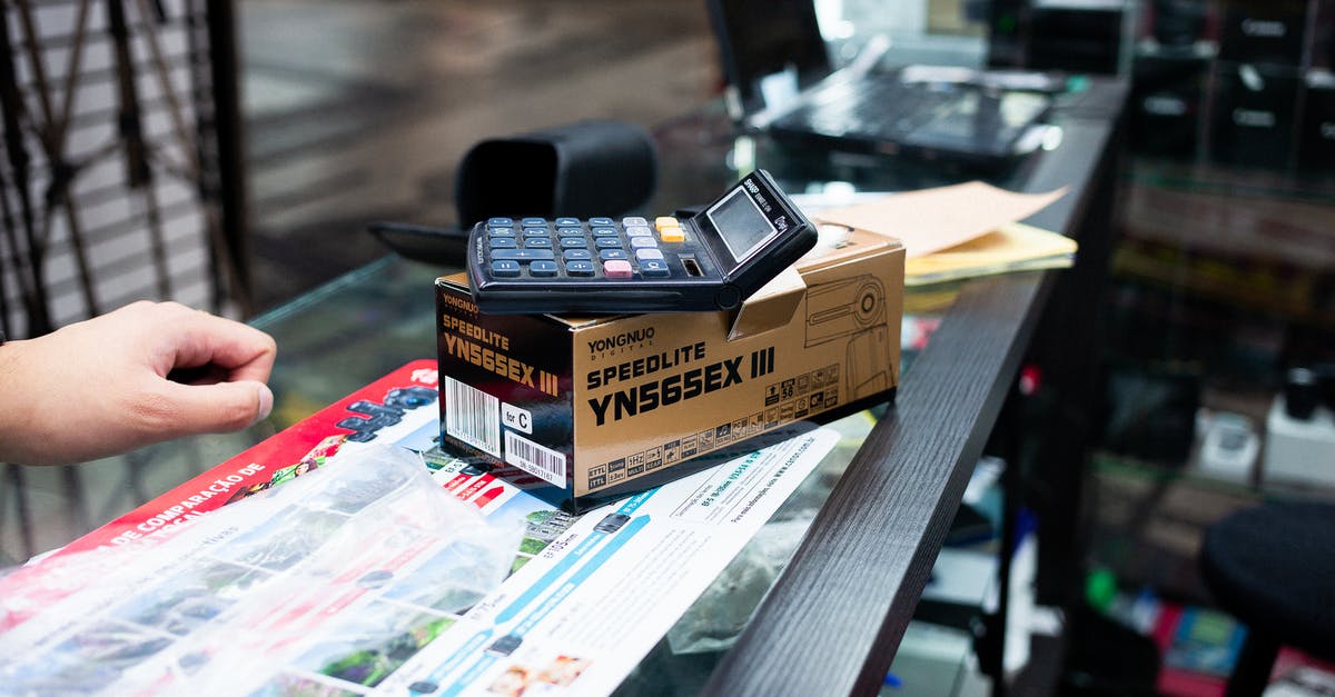 Selling an imported second hand motorcycle in Pakistan - Black and Silver Flip Phone on Brown Wooden Table