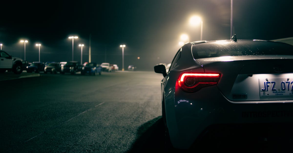 Sending cash by Polish post - Sports car with luminous taillights on parking lot