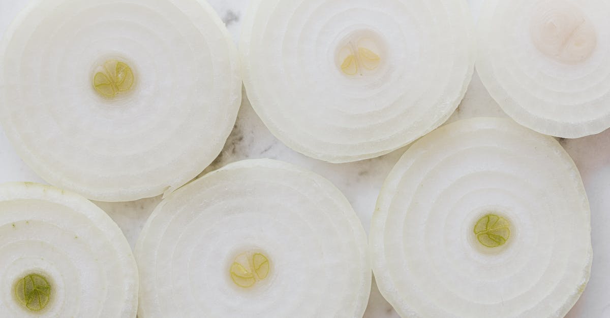 Sending cut orchids from Singapore to Australia [closed] - Top view closeup of ripe organic yellow peeled onion cut into rings and placed on white marble tabletop