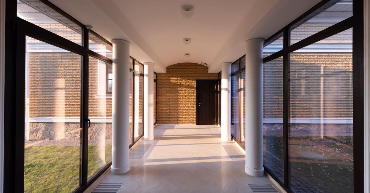 Sending gifts home during long trips - Corridor of modern building with glass walls