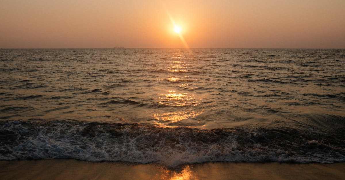 Setting up a tent on a beach in Greece - Ocean Waves Crashing on Shore during Sunset