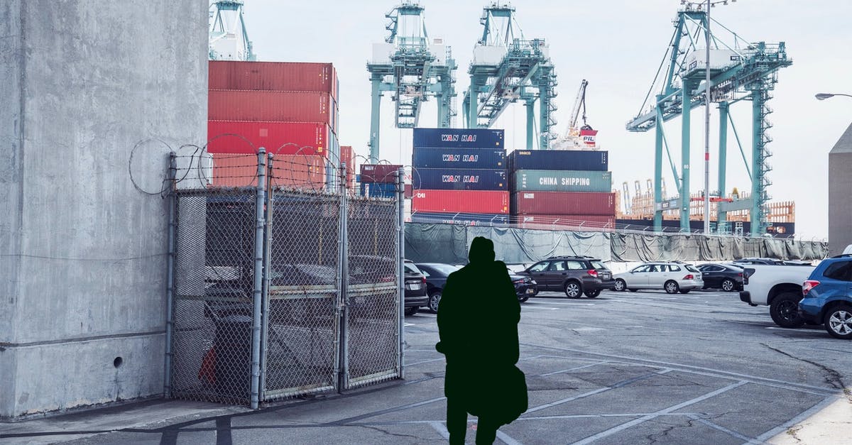 Shipping luggage vs. checking it for US domestic air travel - Unrecognizable man standing in cargo port