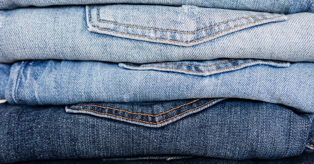 Short-term luggage storage in Alpe d'Huez - Closeup of stack of blue denim pants neatly arranged according to color from lightest to darkest