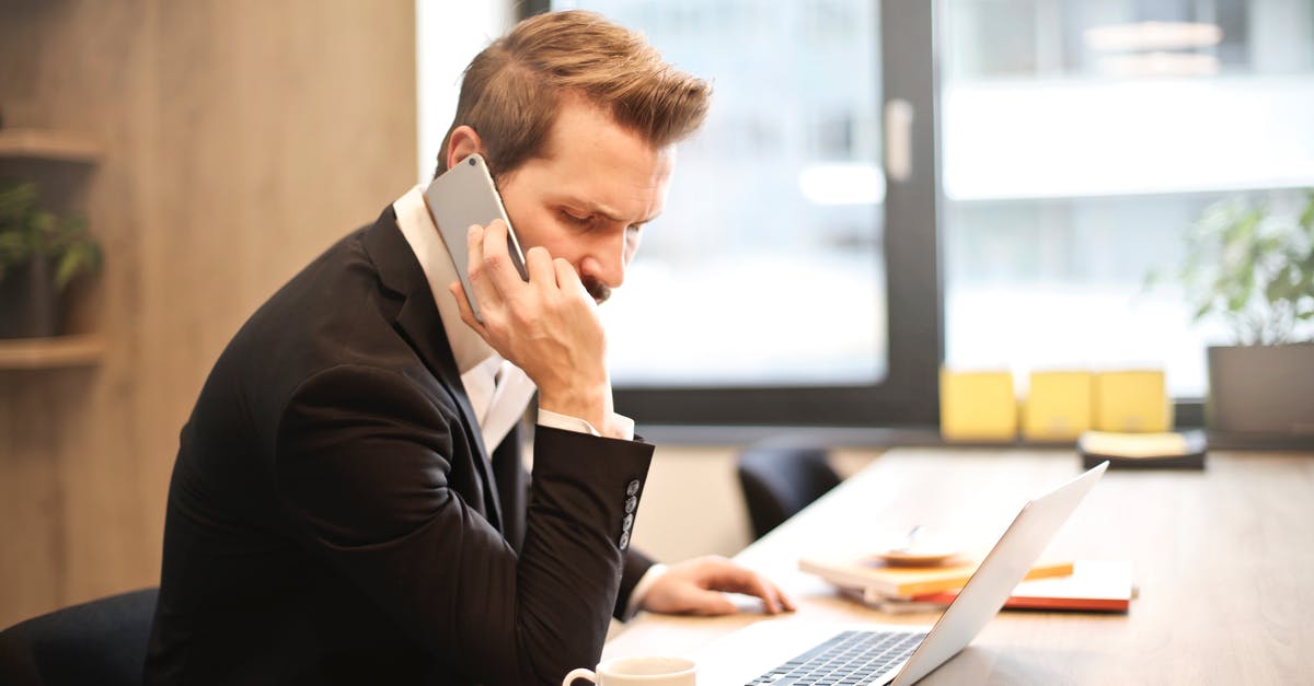 Short-term mobile plans for Japan with voice calling - Man Having a Phone Call In-front of a Laptop