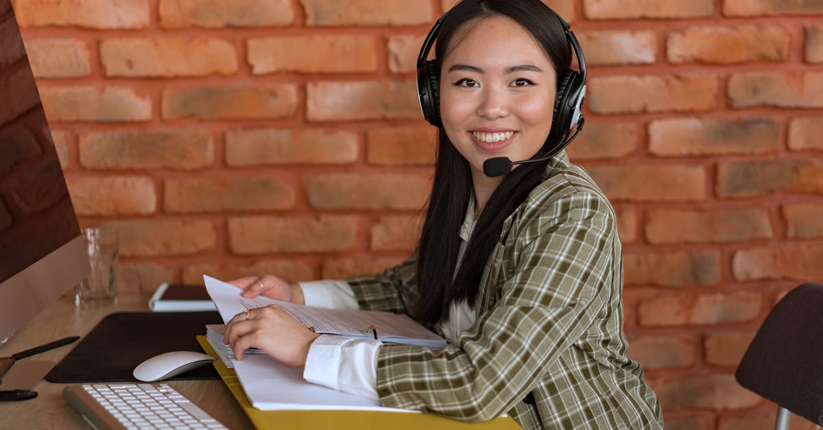 Shoul supporting documents for a Schengen visa be translated? - Woman in Plaid Blazer with Headset Looking at Camera