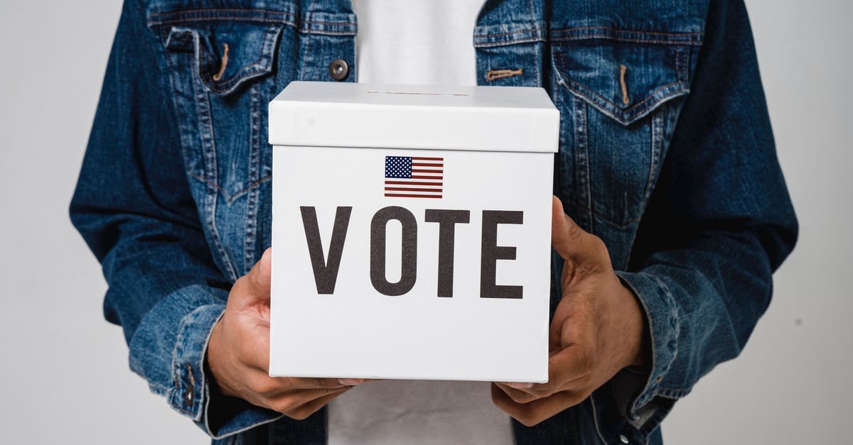 Should a non-EU citizen always carry his/her passport in Germany? - A Person Holding a Ballot Box