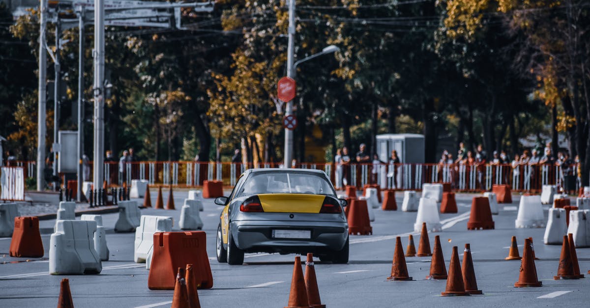 Should I contest this right on red traffic violation [closed] - Participant in car race maneuvering between red and white traffic cones or barriers in front of audience