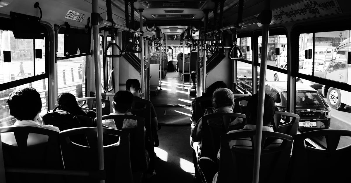 Should I make bus reservations in Mexico in early spring? - Grayscale Photo Of People Sitting Inside A Bus