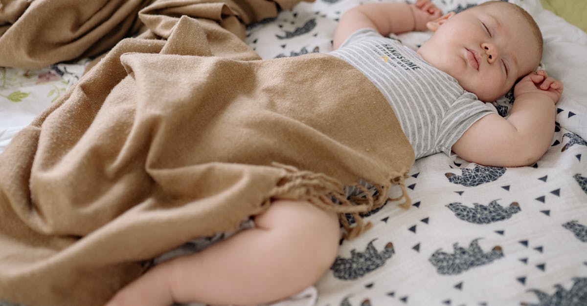 Should I purchase Baby Carseat for 6 months baby? [closed] - Baby in Brown Blanket Lying on White and Black Floral Textile