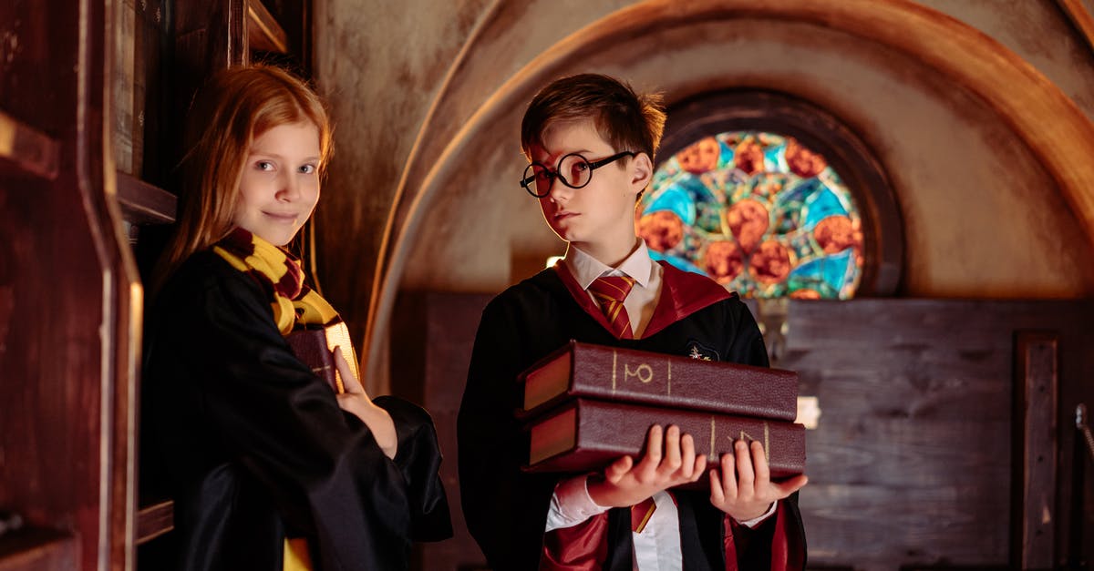 Should I put books in carry-on or checked luggage? - A Boy Holding Books with a Girl