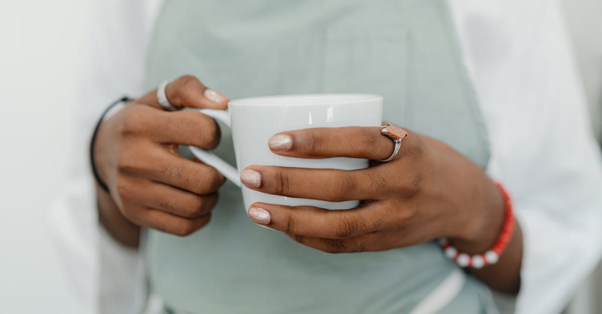 Should I take my own coffee to Japan? - Crop young black woman in apron in coffee shop