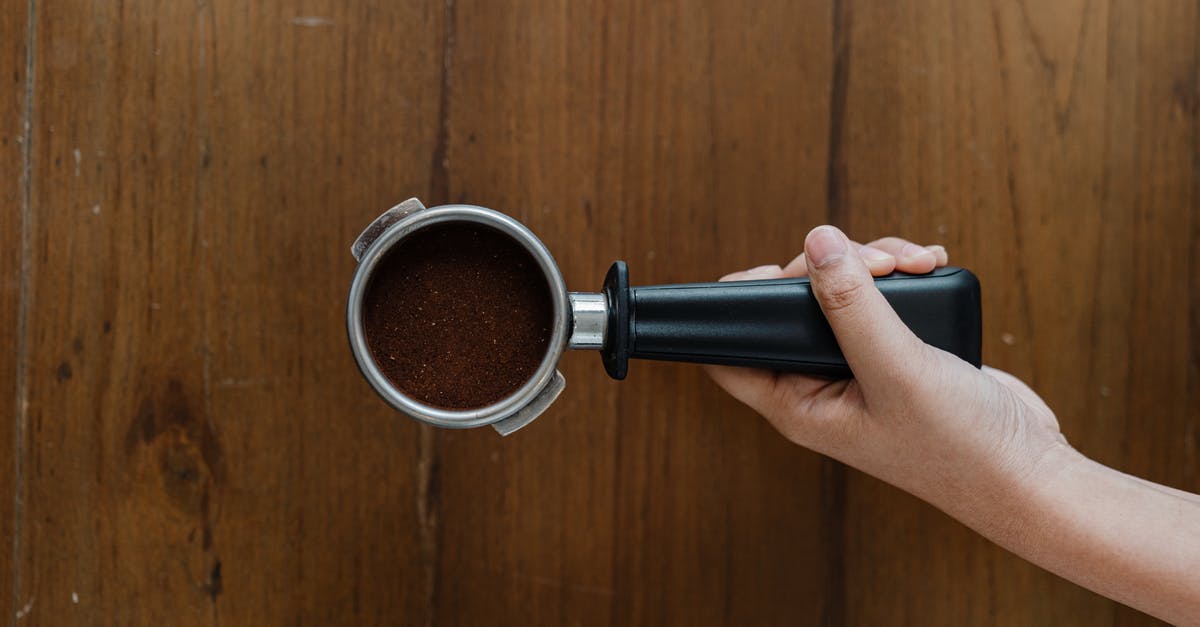 Should I take my own coffee to Japan? - Crop person putting portafilter on wooden table