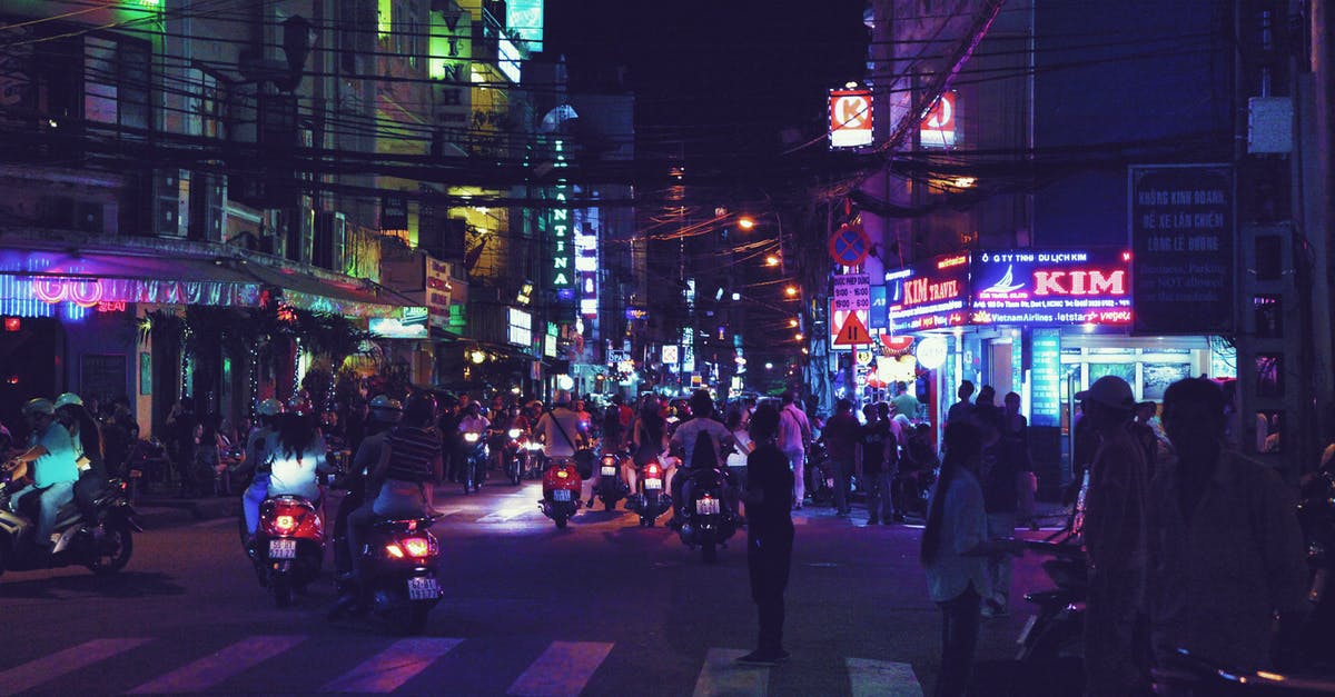 Should I walk facing traffic when walking on a bike trail? - Crowded city street at night in Asian country