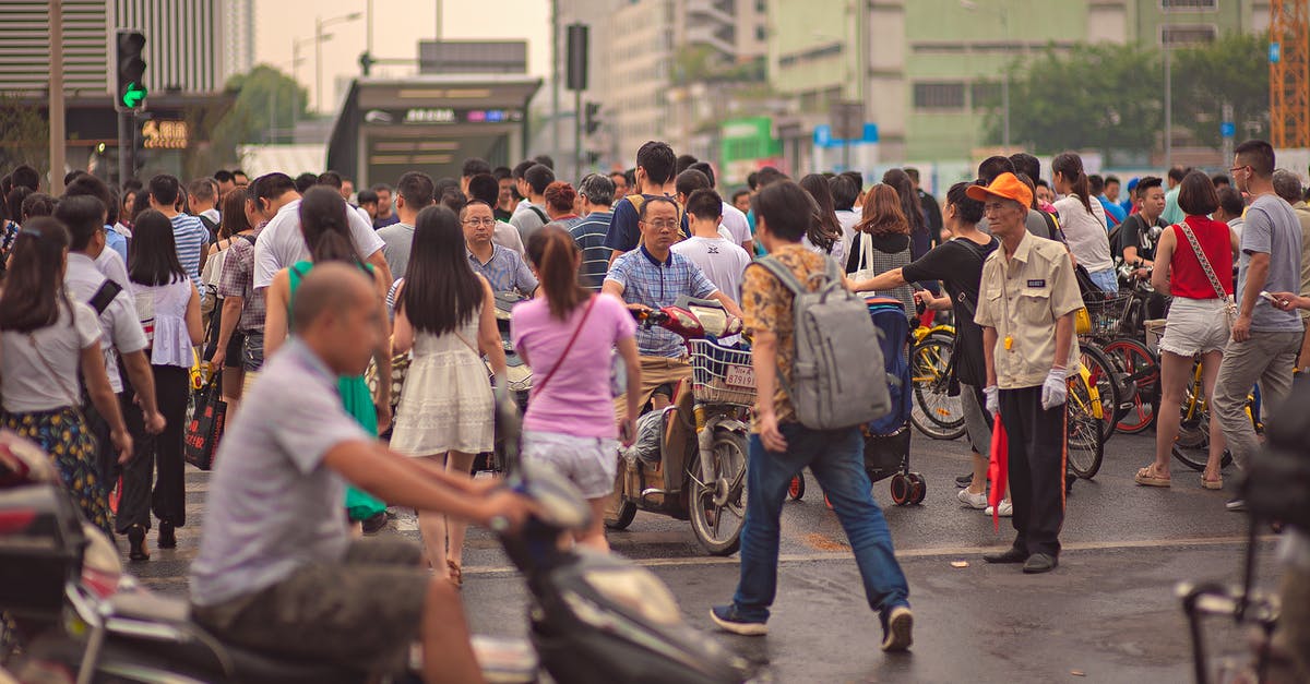 Should I walk facing traffic when walking on a bike trail? - Unrecognizable Asian citizens walking on urban pavement