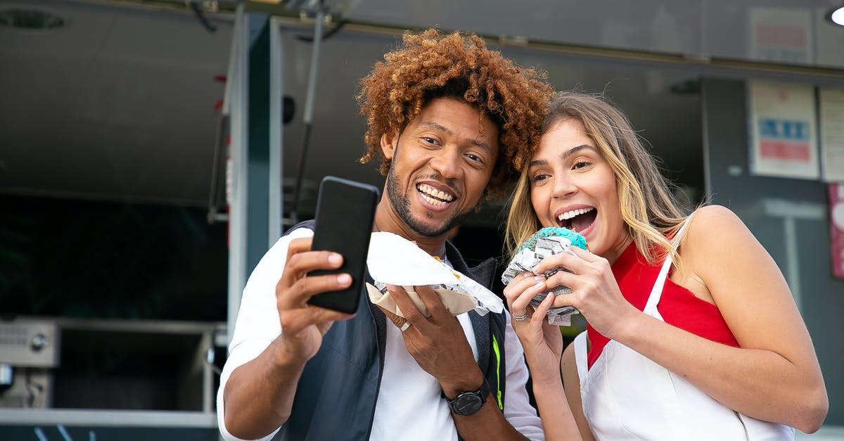 Shower at a truck stop for a couple travelling in car - Happy friends taking selfie with tasty burgers Shower at a truck stop for a couple travelling in car - Happy friends taking selfie with tasty burgers