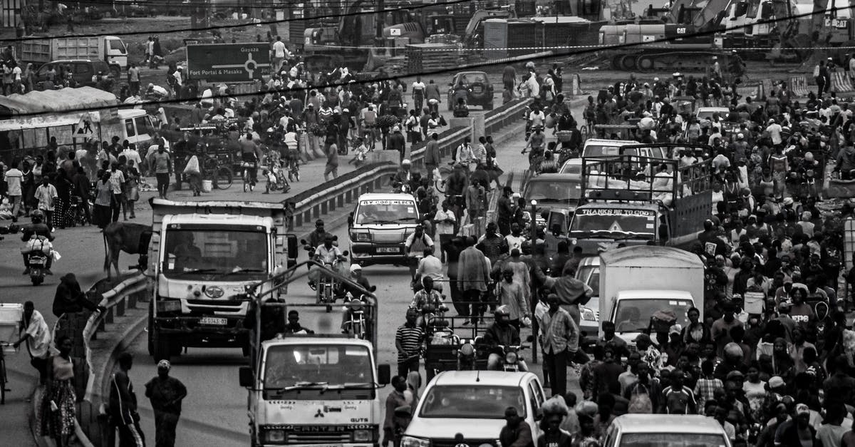 Shower at a truck stop for a couple travelling in car - Crowd and cars on road in city Shower at a truck stop for a couple travelling in car - Crowd and cars on road in city