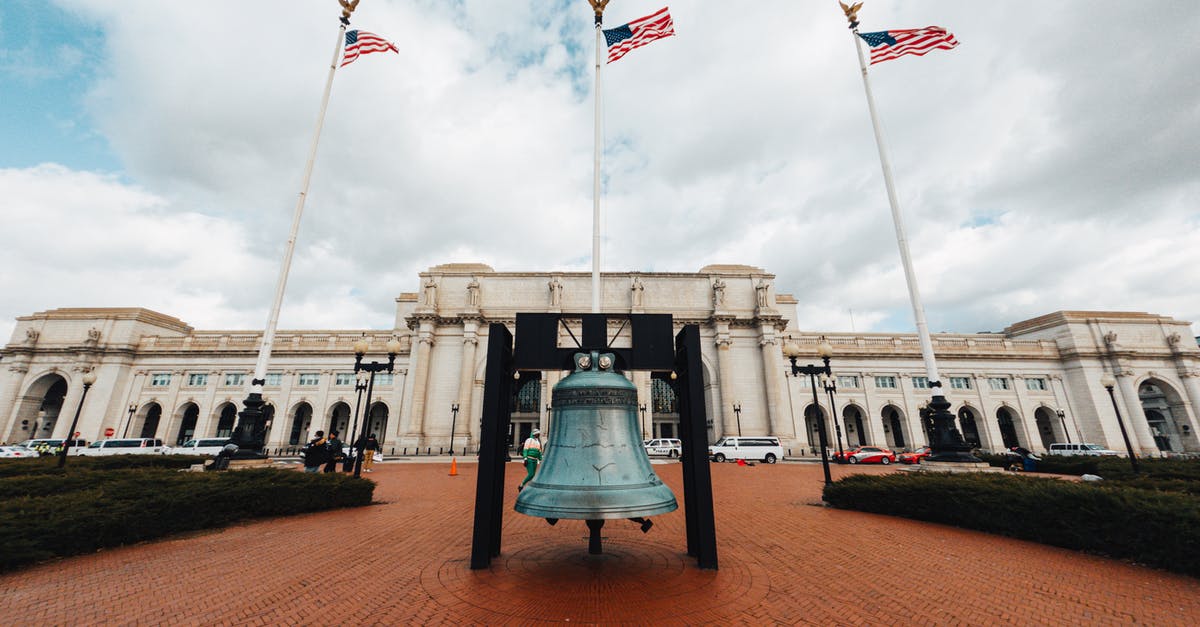 Showers near Denver Union Station? - Old building facade against bell and flags in town