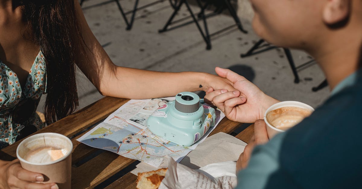 Sightseeing and food in Riga [closed] - Couple having coffee in outdoor cafe during trip together